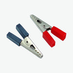Two alligator clips, one blue and one red, on a white background.
